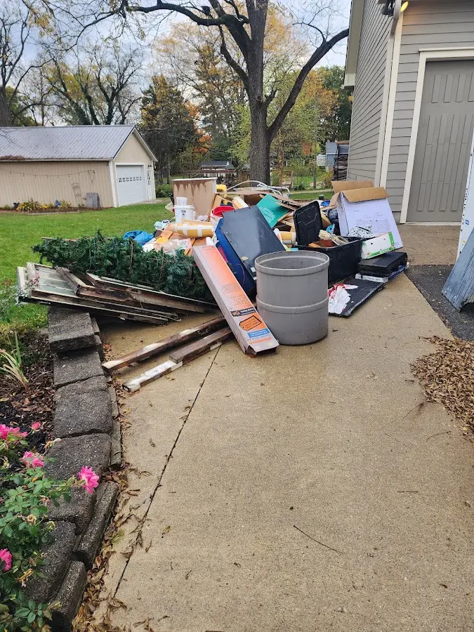Dumpster being loaded with debris for Roofing Dumpster Rental in Roosevelt Park